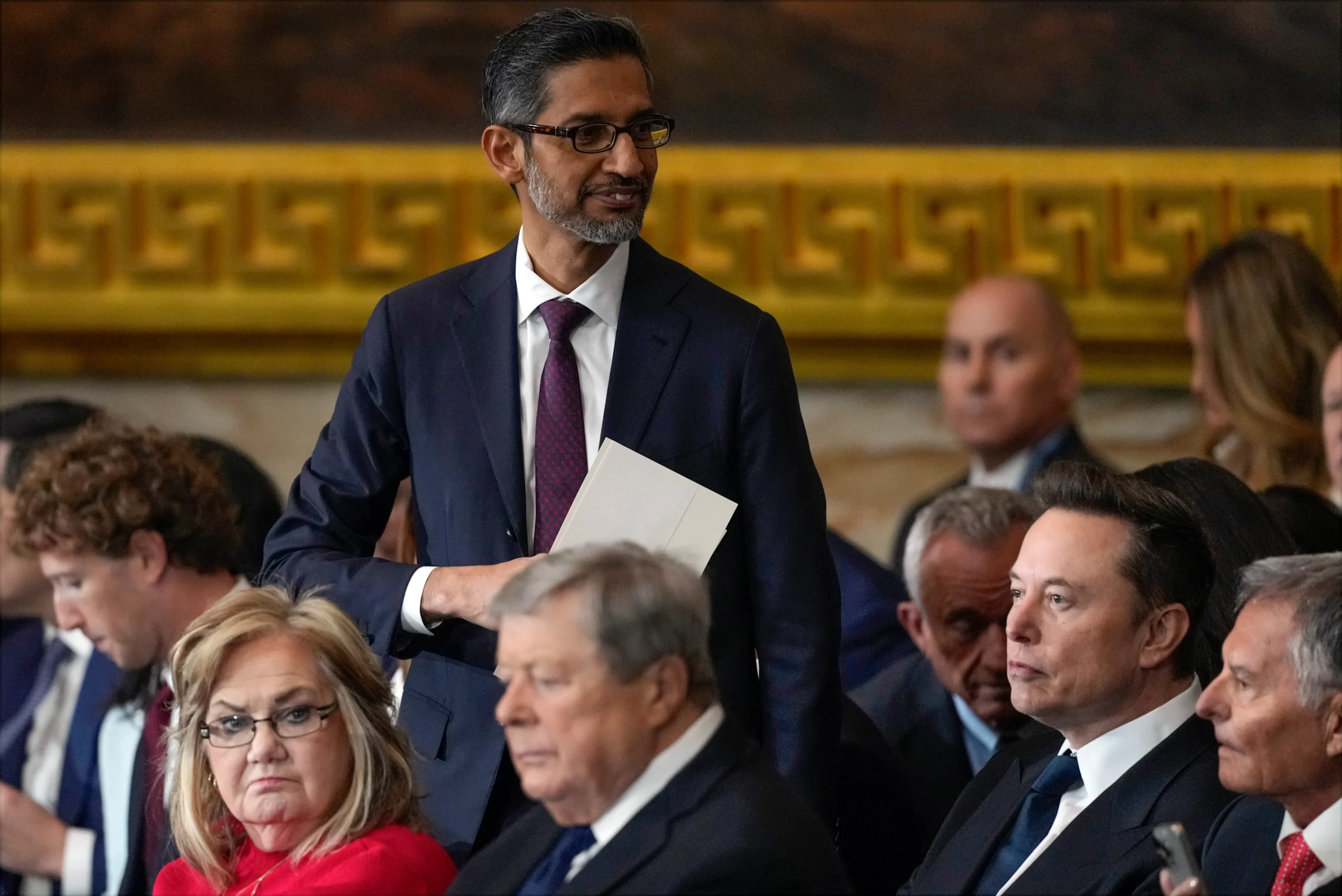 Sundar Pichai standing among seated attendees at the inauguration
